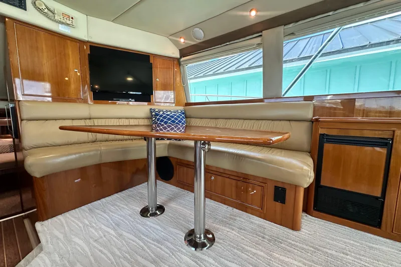 Slide: The Image of Luxurious interior of 2005 Riviera 47 Open Flybridge yacht with leather seating and wooden table. - 83