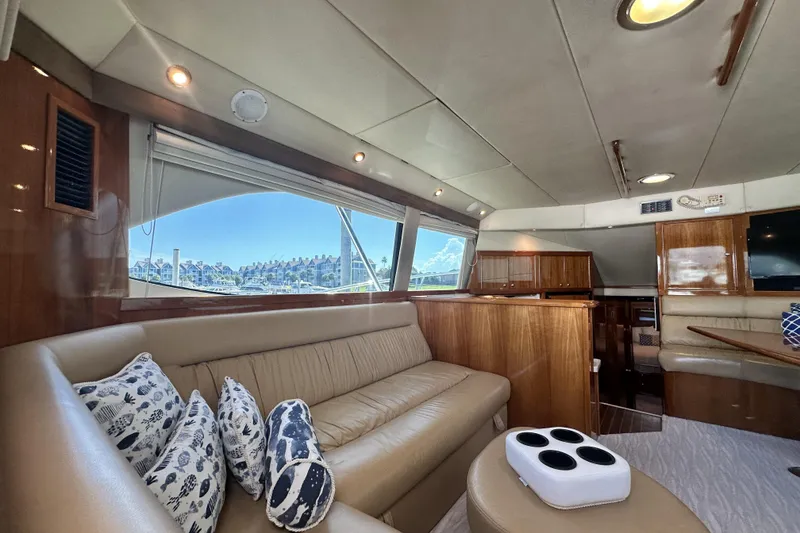 Slide: The Image of Luxurious interior of 2005 Riviera 47 Open Flybridge yacht with plush seating and scenic window view. - 86