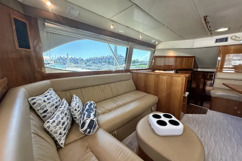 Slide: The Image of Luxurious interior of 2005 Riviera 47 Open Flybridge yacht with plush seating and scenic window view. - 87