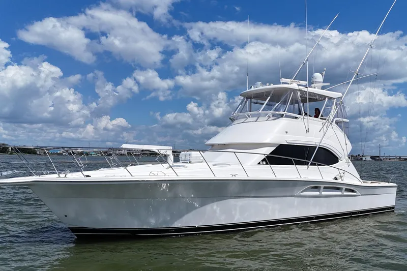 Slide: The Image of 2005 Riviera 47 Open Flybridge yacht on water under blue sky. - 9