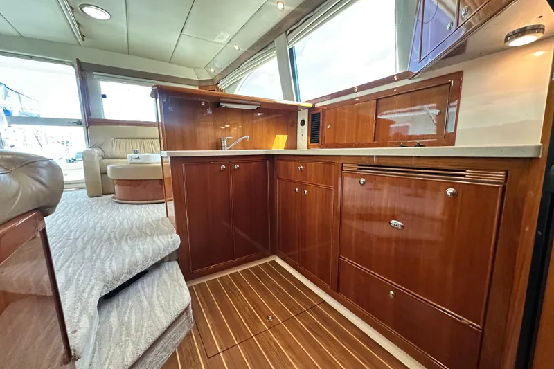Slide: The Image of Luxurious interior of 2005 Riviera 47 Open Flybridge yacht with elegant wood cabinetry. - 91