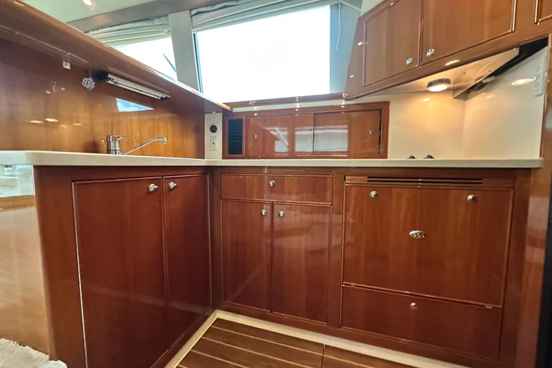 Slide: The Image of Luxurious wooden kitchen interior of 2005 Riviera 47 Open Flybridge yacht. - 94