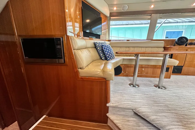 Slide: The Image of Luxurious interior of 2005 Riviera 47 Open Flybridge yacht with leather seating and modern amenities. - 97