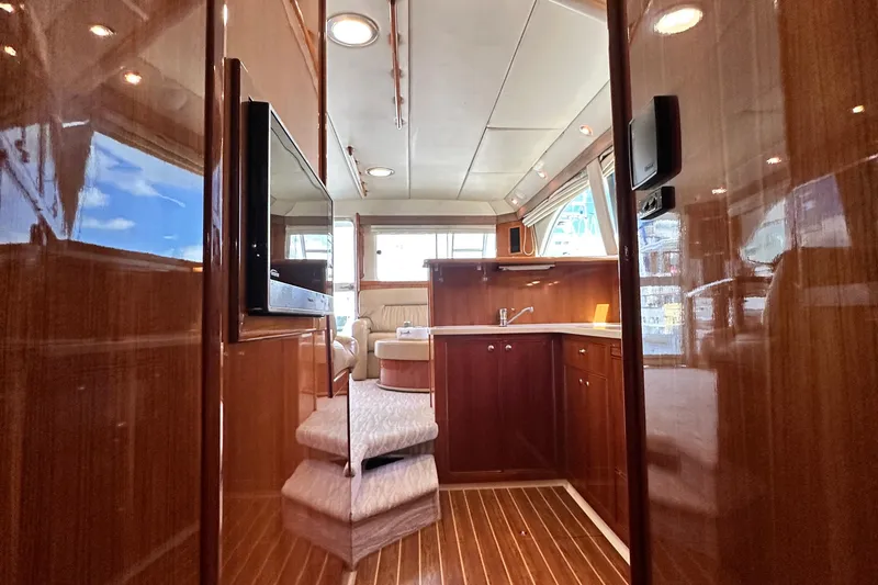 Slide: The Image of Luxurious interior of 2005 Riviera 47 Open Flybridge yacht with polished wood and modern amenities. - 99