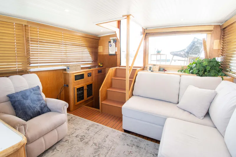 Slide: The Image of Interior of 1989 Chris-Craft Catalina boat with cozy seating and wooden accents. - 15