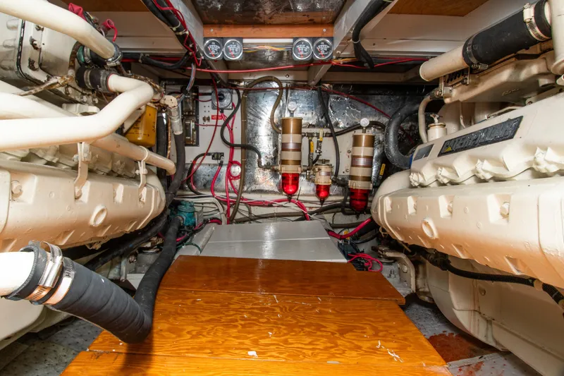 Slide: The Image of Engine room of a 1989 Chris-Craft Catalina boat, showcasing dual engines and wiring. - 28
