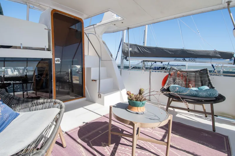 Slide: The Image of 1989 Chris-Craft Catalina yacht deck with modern seating and table, docked at marina. - 5