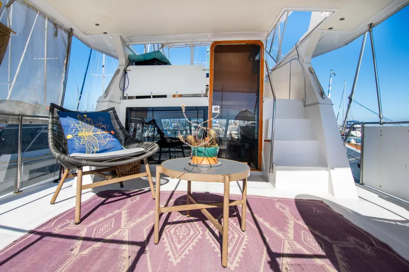Slide: The Image of 1989 Chris-Craft Catalina yacht deck with modern seating and nautical decor. - 6