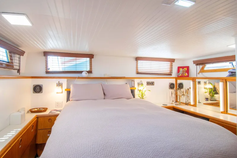 Slide: The Image of Cozy bedroom interior of 1989 Chris-Craft Catalina boat with wooden accents and soft lighting. - 7