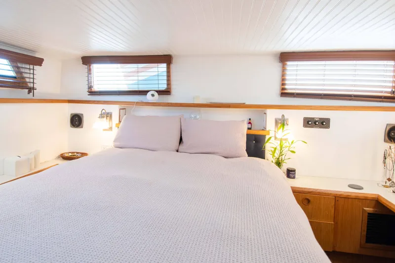 Slide: The Image of Cozy bedroom interior on 1989 Chris-Craft Catalina boat with natural light and wooden accents. - 8