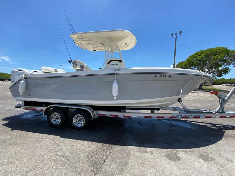 Slide: The Image of 2017 Century 2600 Center Console boat on trailer under clear blue sky. - 1