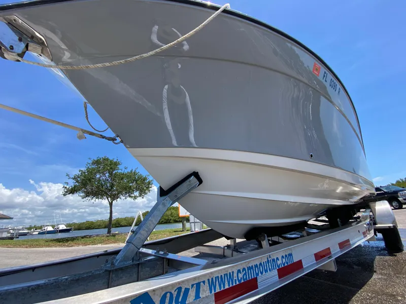 Slide: The Image of 2017 Century 2600 Center Console boat on trailer under clear blue sky. - 10
