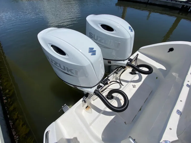 Slide: The Image of Twin Suzuki outboard motors on a 2017 Century 2600 Center Console boat. - 17