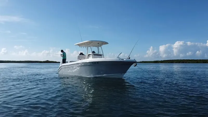 Slide: The Image of 2017 Century 2600 Center Console boat on calm water, person fishing. - 2