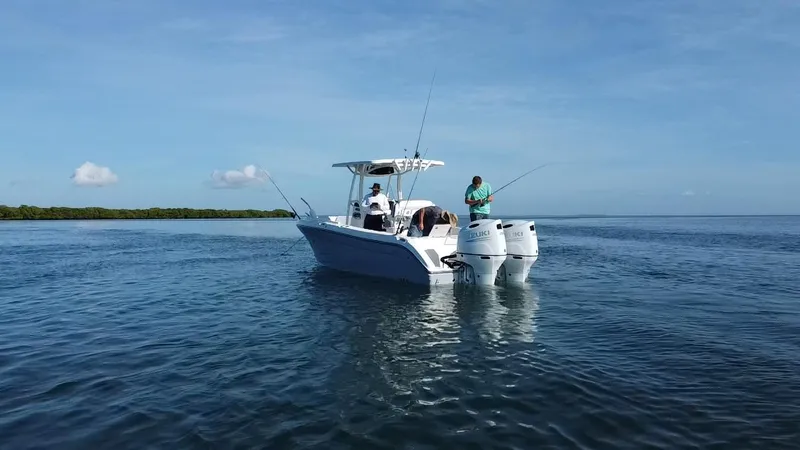 Slide: The Image of 2017 Century 2600 Center Console boat with anglers fishing on calm waters. - 21
