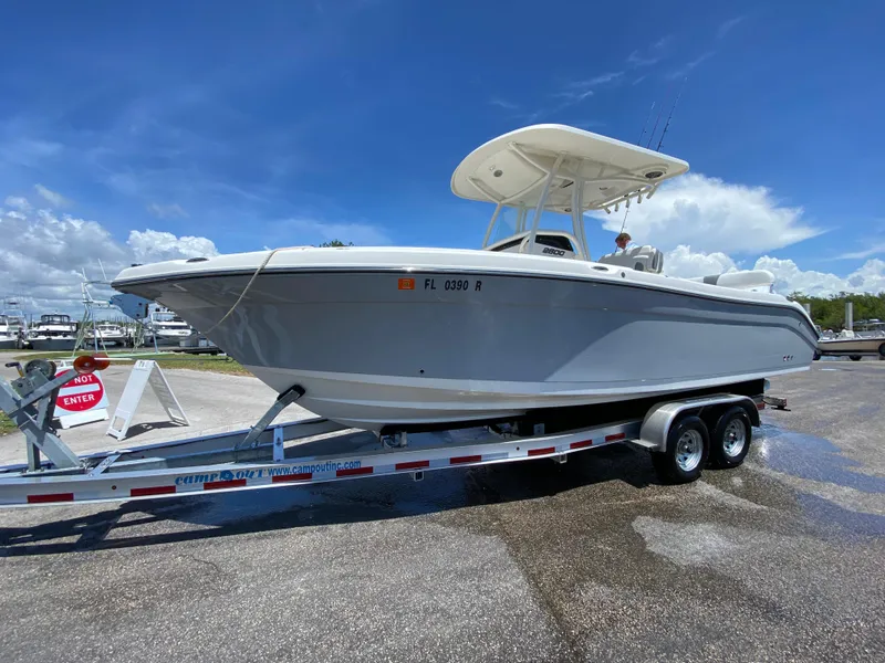 Slide: The Image of 2017 Century 2600 Center Console boat on trailer under clear blue sky. - 6
