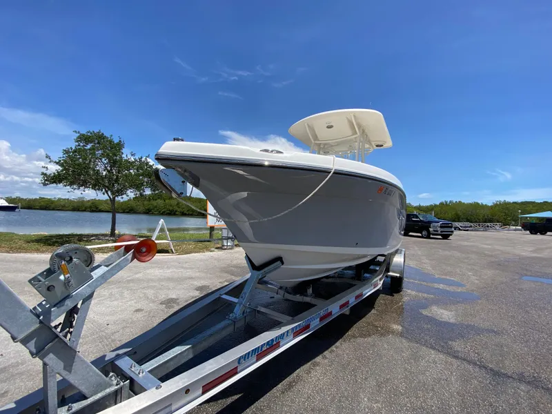Slide: The Image of 2017 Century 2600 Center Console boat on trailer, parked near a scenic waterfront. - 7