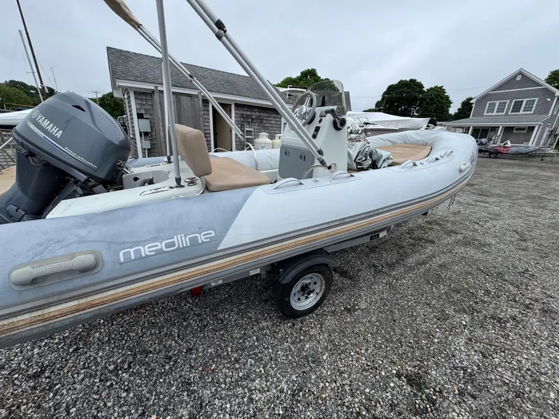 Slide: The Image of 2018 Zodiac Pro Open 550 boat with Yamaha engine on trailer, parked outdoors. - 6