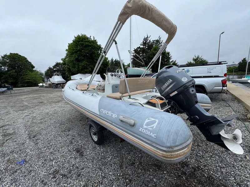 Slide: The Image of 2018 Zodiac Pro Open 550 inflatable boat with Yamaha engine, parked on gravel. - 9