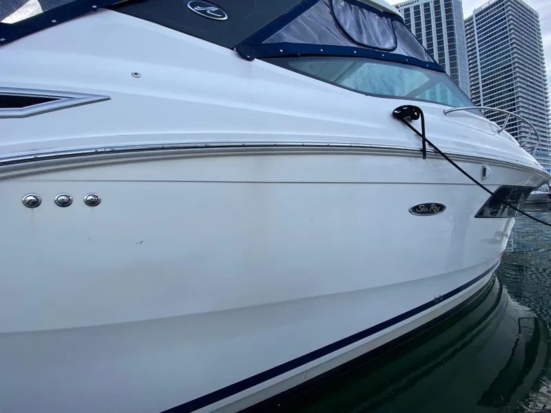 Slide: The Image of 2020 Sea Ray Sundancer 320 OB docked near city buildings. - 10