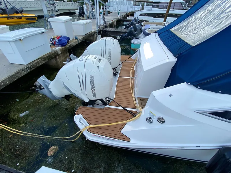 Slide: The Image of 2020 Sea Ray Sundancer 320 OB with twin Mercury outboard engines docked at marina. - 13