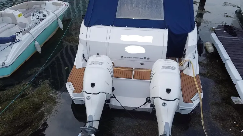 Slide: The Image of 2020 Sea Ray Sundancer 320 OB with twin outboard engines docked at marina. - 14