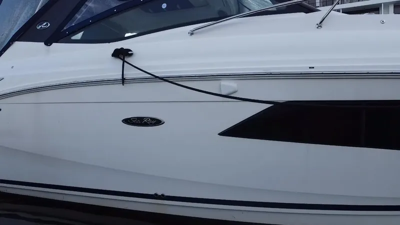 Slide: The Image of 2020 Sea Ray Sundancer 320 OB boat side view, featuring sleek white design. - 16