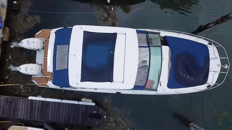 Slide: The Image of Aerial view of 2020 Sea Ray Sundancer 320 OB docked, showcasing sleek design and dual outboard engines. - 18