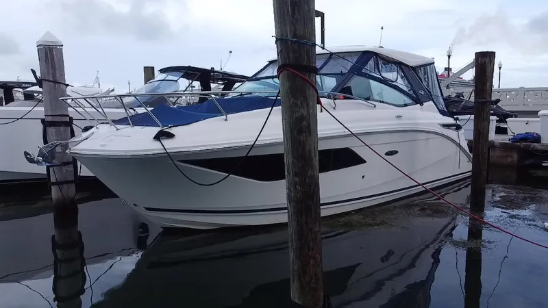 Slide: The Image of 2020 Sea Ray Sundancer 320 OB docked at marina, side view. - 3
