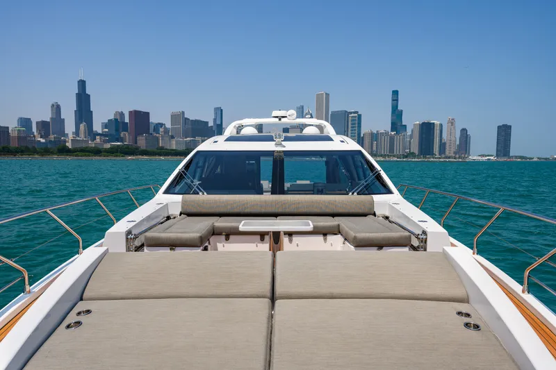 Slide: The Image of 2019 Azimut S7 yacht with city skyline in the background, cruising on clear blue waters. - 11