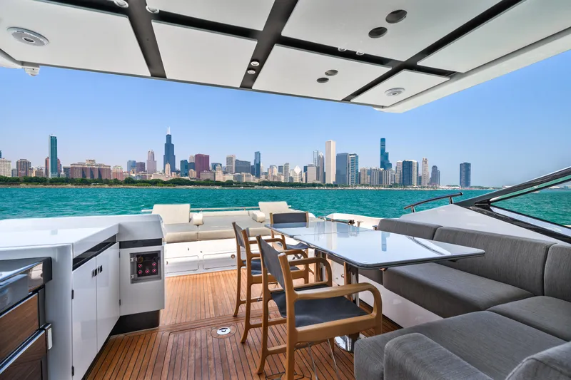 Slide: The Image of Luxurious 2019 Azimut S7 yacht with city skyline view, featuring elegant outdoor seating. - 16