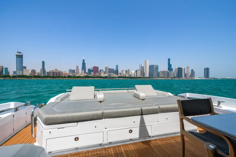 Slide: The Image of 2019 Azimut S7 yacht with city skyline view, featuring spacious deck and luxurious seating. - 17