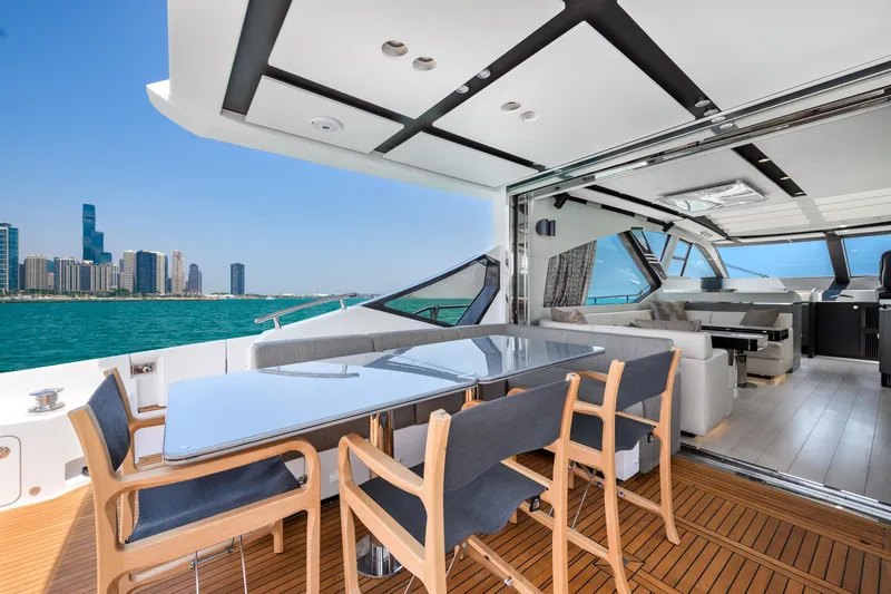 Slide: The Image of Luxurious 2019 Azimut S7 yacht with elegant dining area and stunning city skyline view. - 18
