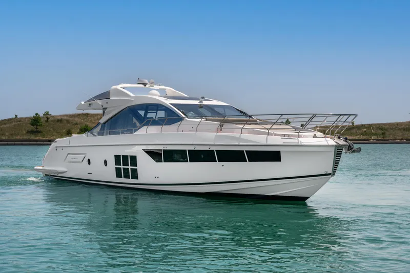 Slide: The Image of 2019 Azimut S7 yacht cruising on calm waters under a clear blue sky. - 2