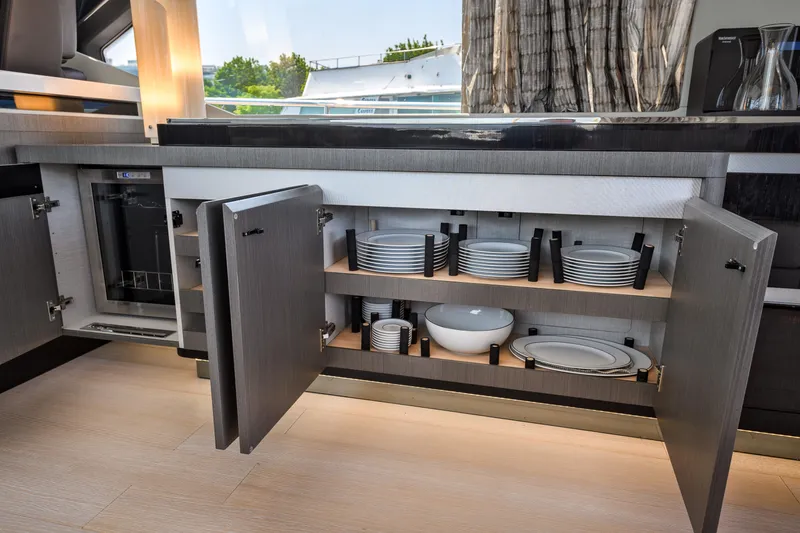 Slide: The Image of Modern kitchen interior of 2019 Azimut S7 yacht with open cabinets displaying dishes. - 25