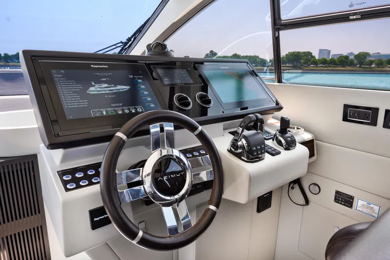 Slide: The Image of 2019 Azimut S7 yacht helm with advanced navigation displays and controls. - 36