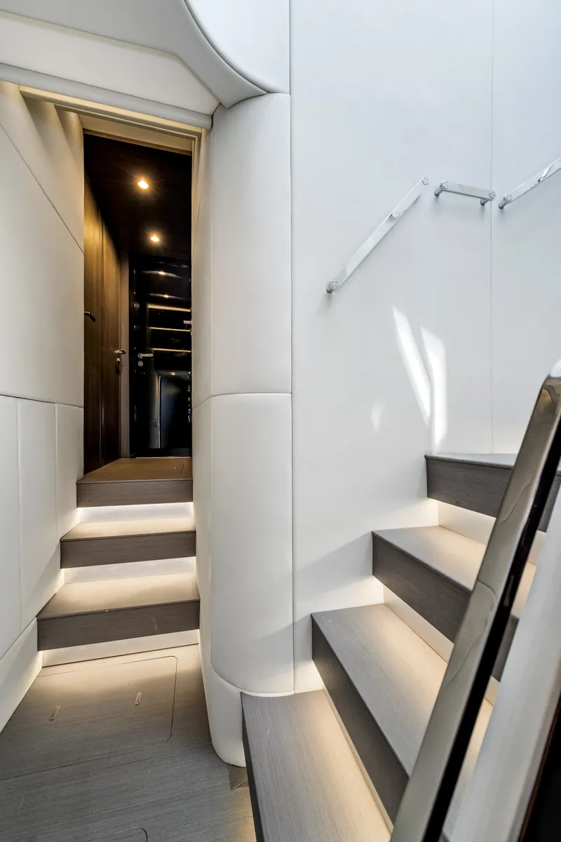 Slide: The Image of Interior staircase of 2019 Azimut S7 yacht, featuring modern design and ambient lighting. - 47