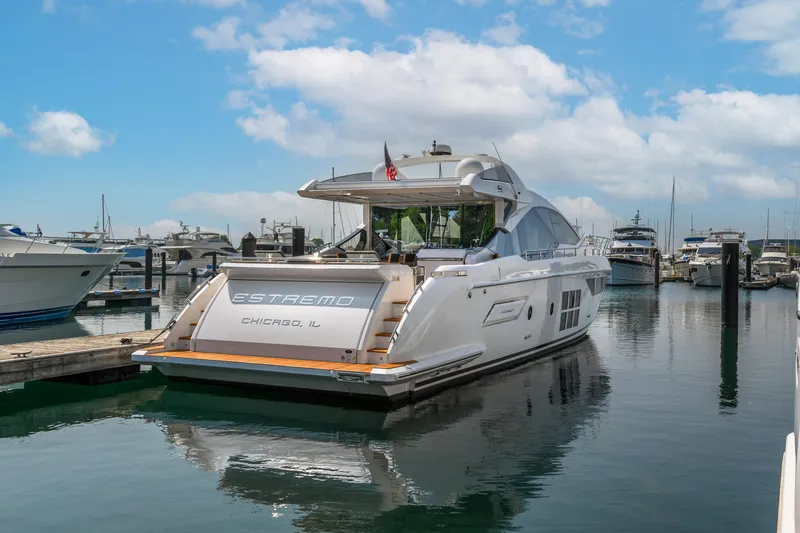 Slide: The Image of 2019 Azimut S7 yacht docked in a marina under a partly cloudy sky. - 5