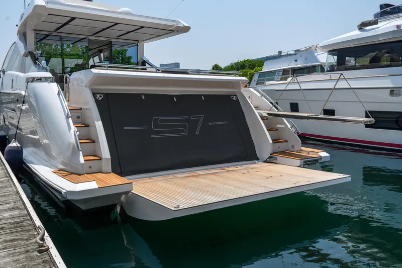 Slide: The Image of 2019 Azimut S7 yacht docked, showcasing sleek design and spacious deck. - 6