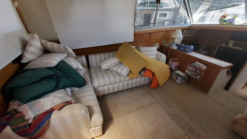 Slide: The Image of Interior of 1985 Silverton 40 Aft Cabin with striped sofas and cozy decor. - 11
