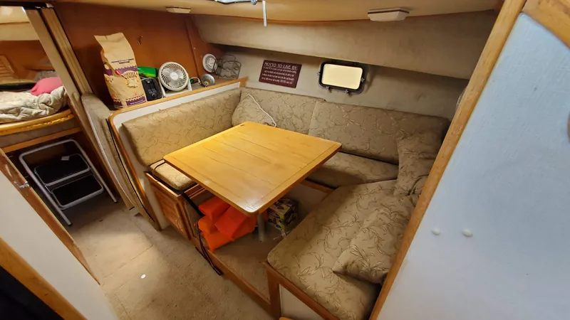Slide: The Image of 1985 Silverton 40 Aft Cabin interior with cozy dining area and wooden table. - 13