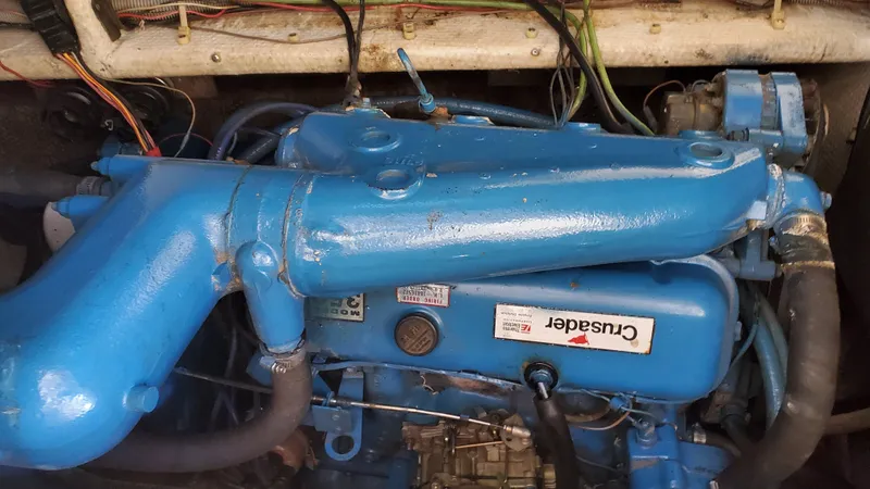 Slide: The Image of 1985 Silverton 40 Aft Cabin Crusader engine, blue, with visible wiring and hoses. - 22