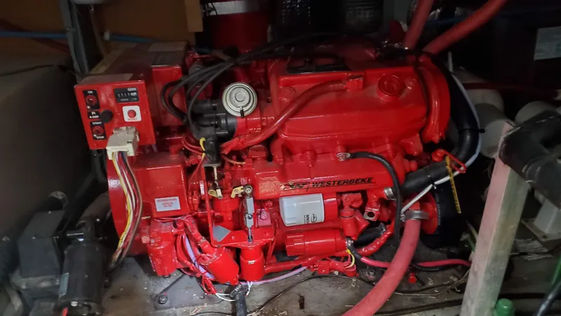 Slide: The Image of Red engine inside a 1985 Silverton 40 Aft Cabin boat, featuring detailed wiring and components. - 23