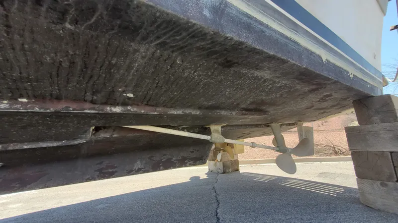 Slide: The Image of 1985 Silverton 40 Aft Cabin boat underside showing propeller and rudder on dry dock. - 27