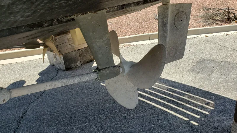 Slide: The Image of Propeller and rudder of a 1985 Silverton 40 Aft Cabin boat on dry land. - 28
