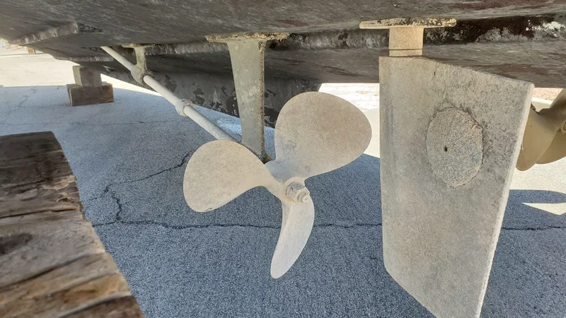 Slide: The Image of 1985 Silverton 40 Aft Cabin boat propeller and rudder detail on dry dock. - 29