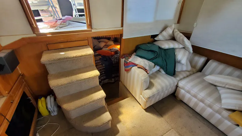 Slide: The Image of Interior of 1985 Silverton 40 Aft Cabin with stairs and cozy seating area. - 43
