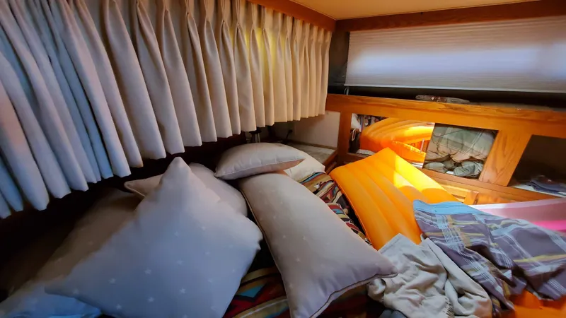 Slide: The Image of Cozy cabin interior of 1985 Silverton 40 Aft Cabin with pillows and bedding. - 6