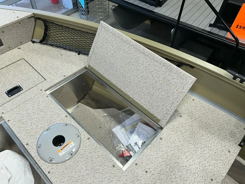 Slide: The Image of 2023 Crestliner 1650 Discovery Tiller boat interior with open storage compartment. - 14