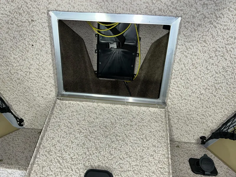 Slide: The Image of 2023 Crestliner 1650 Discovery Tiller boat interior storage compartment with carpeted finish. - 15